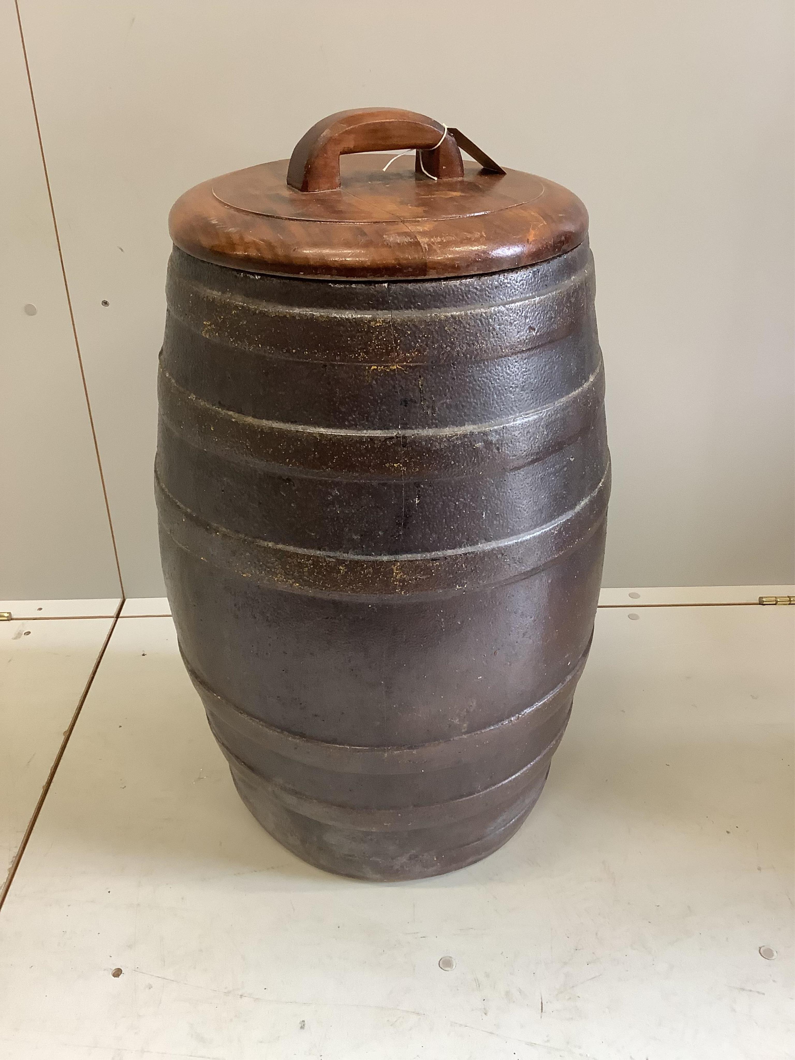 A Victorian salt glazed earthenware barrel with associated wood cover, diameter 40cm, height 73cm. Condition - good